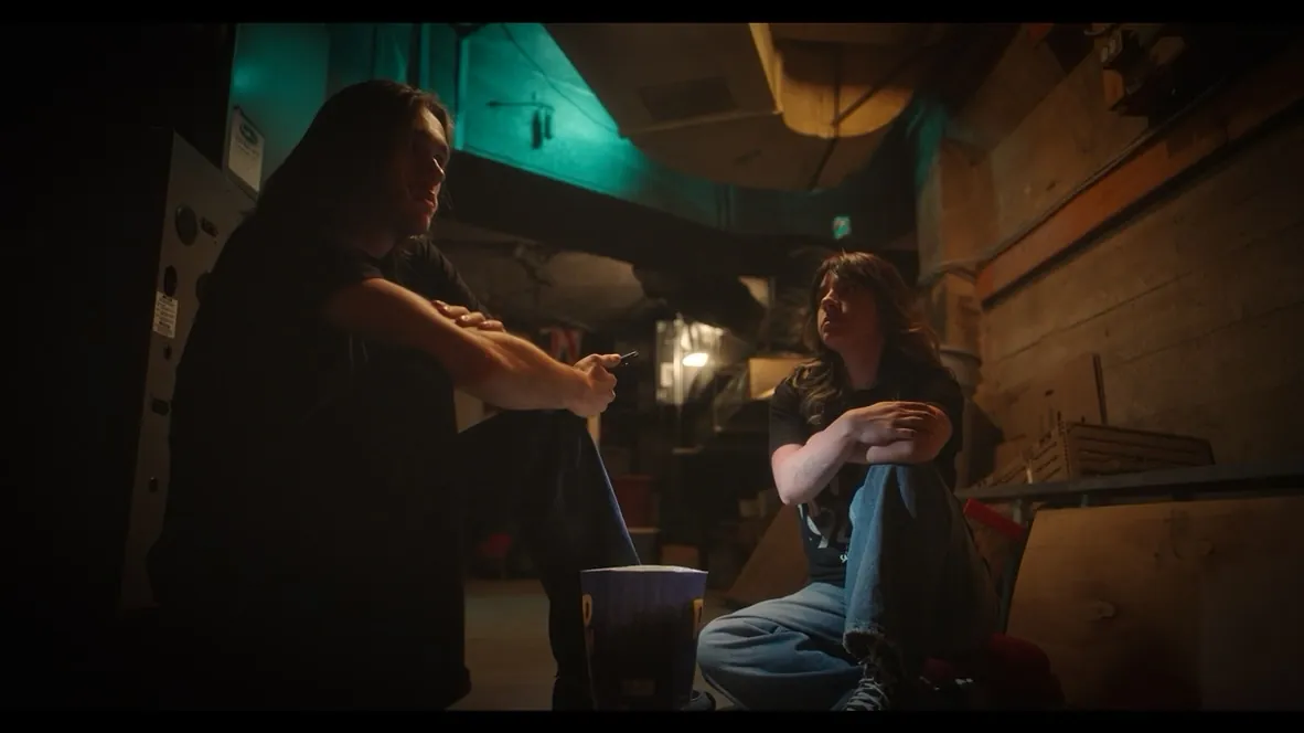 Two theatre employees in the projection booth